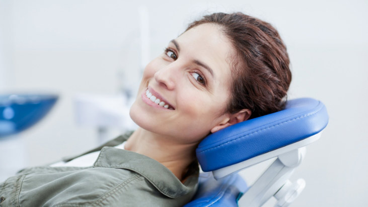 A Beautiful Women Sitting On A Dental Chair Is Excited For Her Dental Treatments